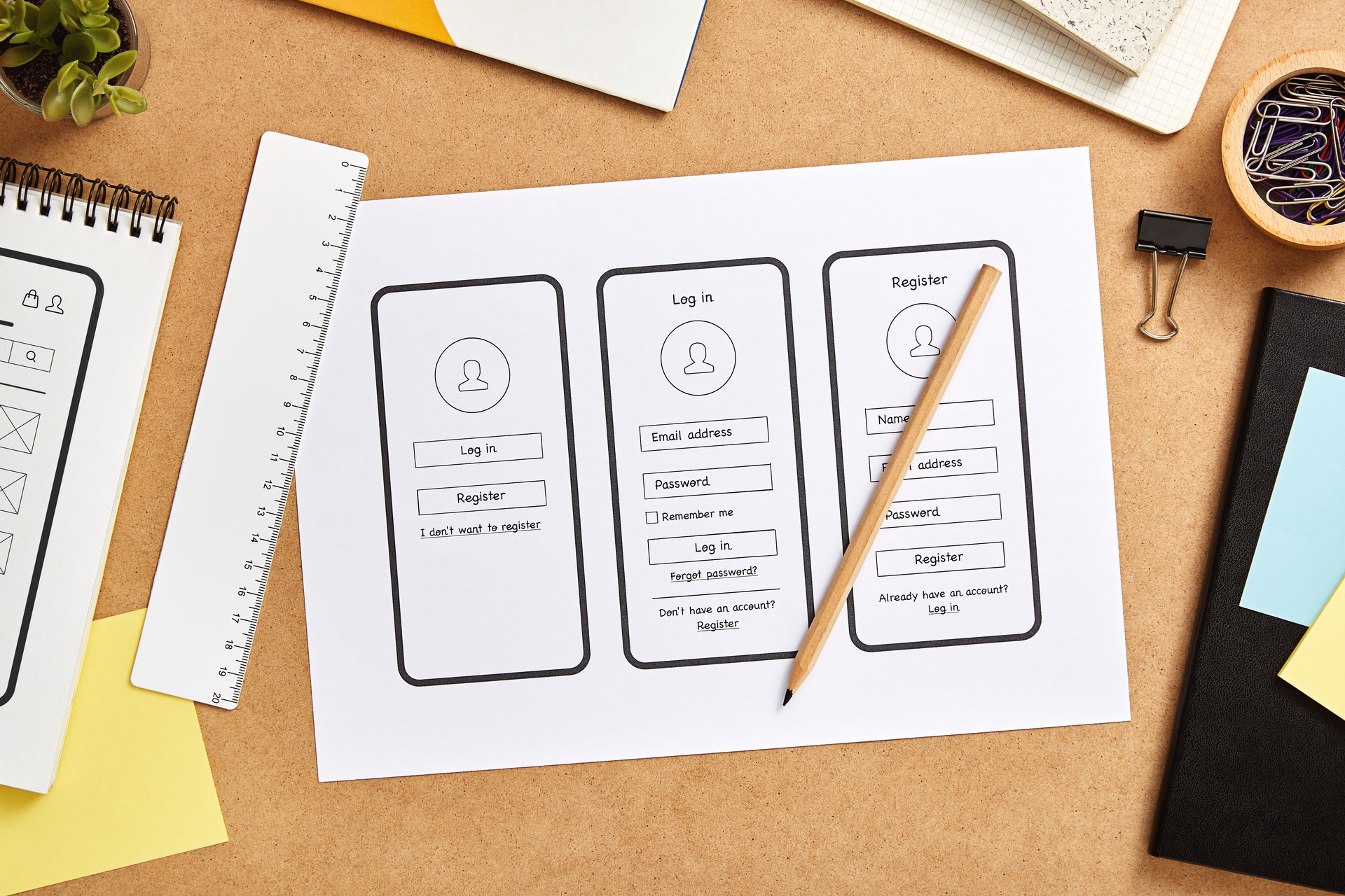 Mobile application wireframes over UX designer desk